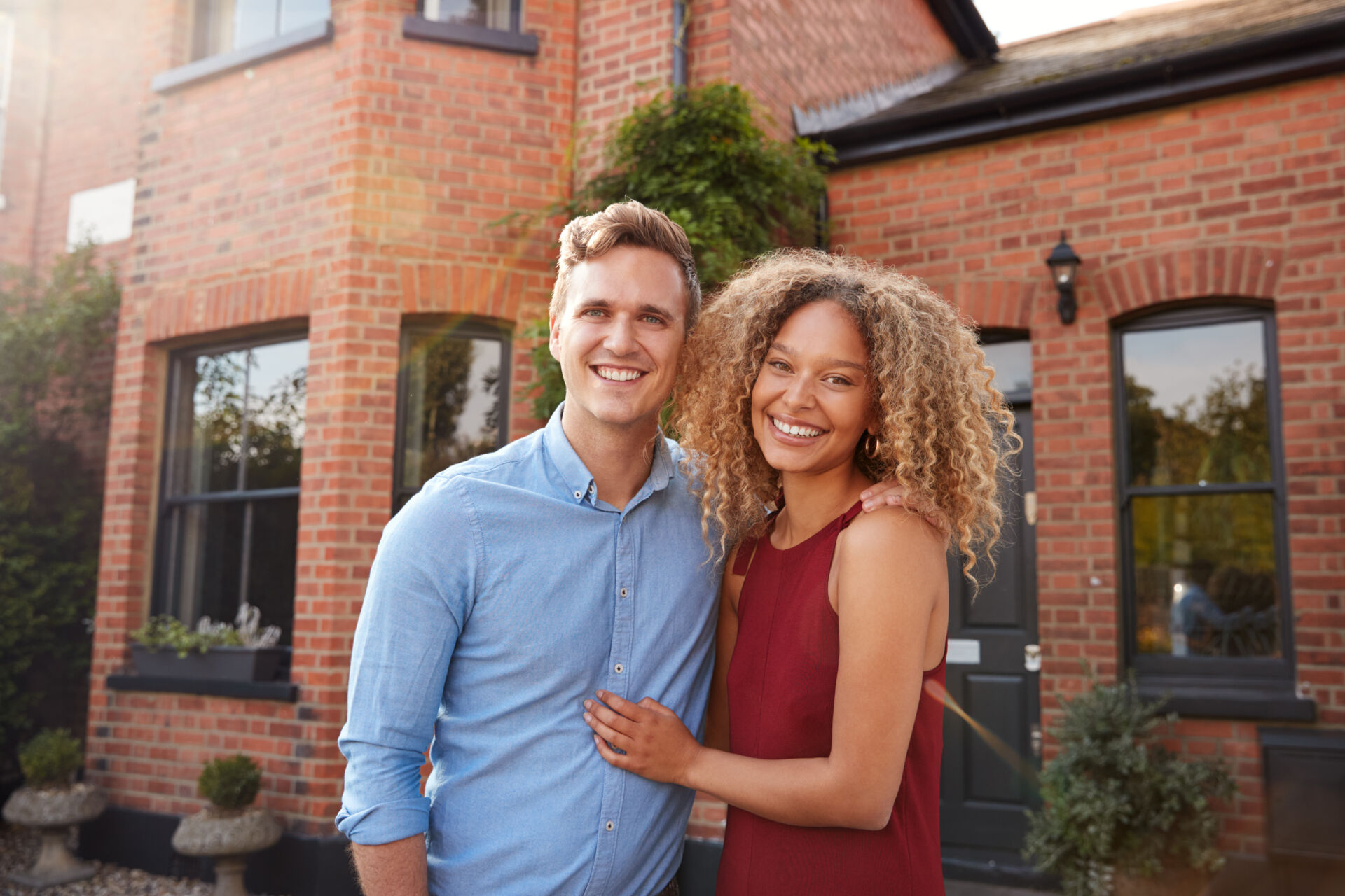 Ashford Lettings - Couple in front of new home in Canterbury, Kent
